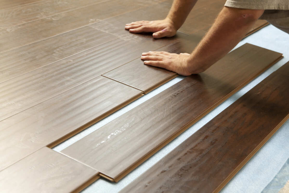 man-installing-new-laminate-wood-flooring-abstract-2